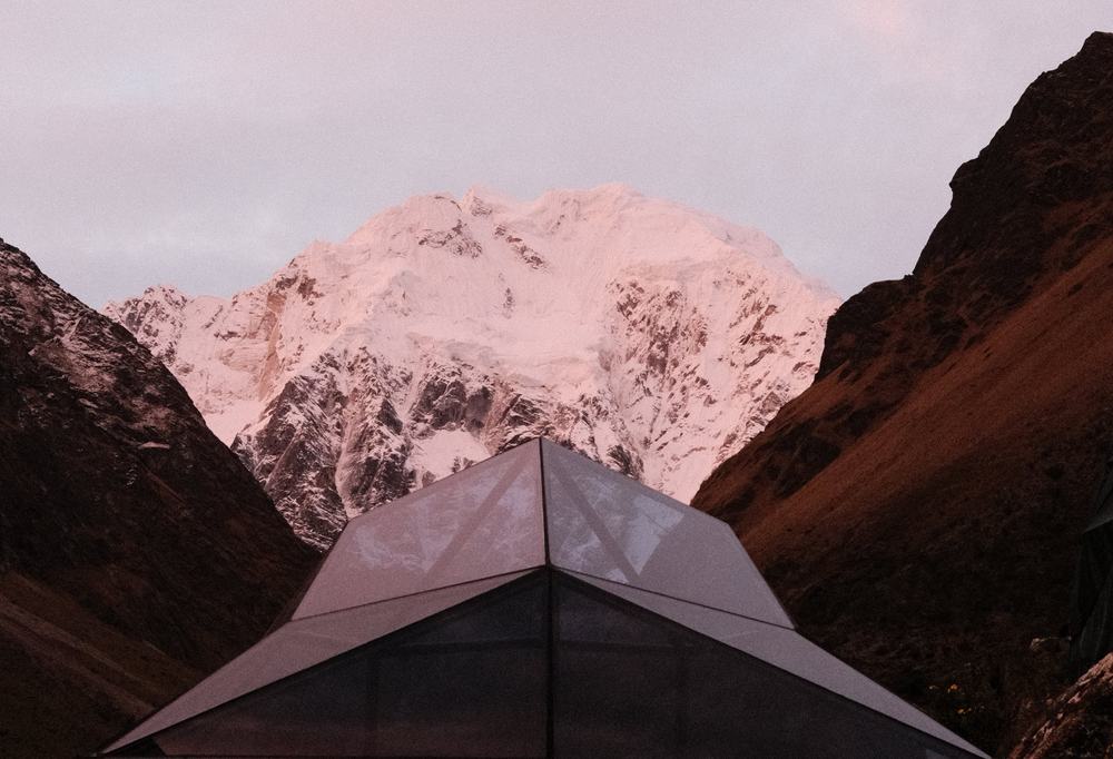 Sunrise over snow-capped peaks near the Salkantay trail, viewed from a dome camp